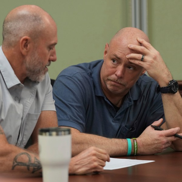 Border Patrol specialist Mitchell Holmes, left, listens to U.S. Fish and Wildlife Regional Law Enforcement agent Kevin Shinn, during a Chaplain Academy training session, Wednesday, Nov. 20, 2024, in Dania Beach, Fla. (AP Photo/Marta Lavandier)