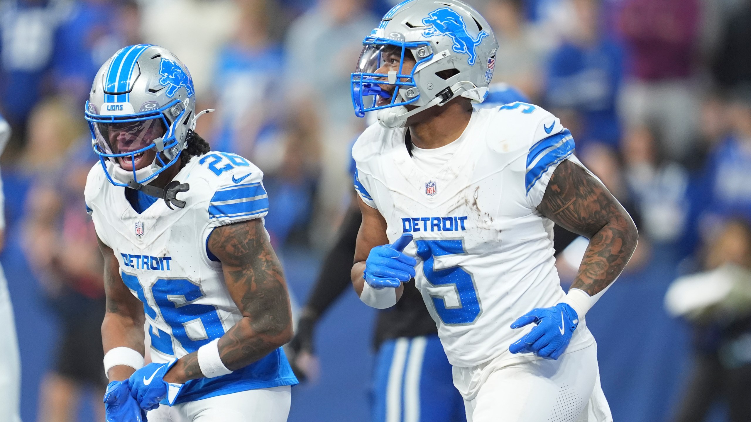 Detroit Lions running back David Montgomery (5) and running back Jahmyr Gibbs (26) celebrate after Montgomery's 6-yard rushing touchdown during the first half of an NFL football game against the Indianapolis Colts, Sunday, Nov. 24, 2024, in Indianapolis. (AP Photo/Michael Conroy)