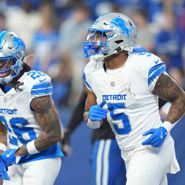 Detroit Lions running back David Montgomery (5) and running back Jahmyr Gibbs (26) celebrate after Montgomery's 6-yard rushing touchdown during the first half of an NFL football game against the Indianapolis Colts, Sunday, Nov. 24, 2024, in Indianapolis. (AP Photo/Michael Conroy)