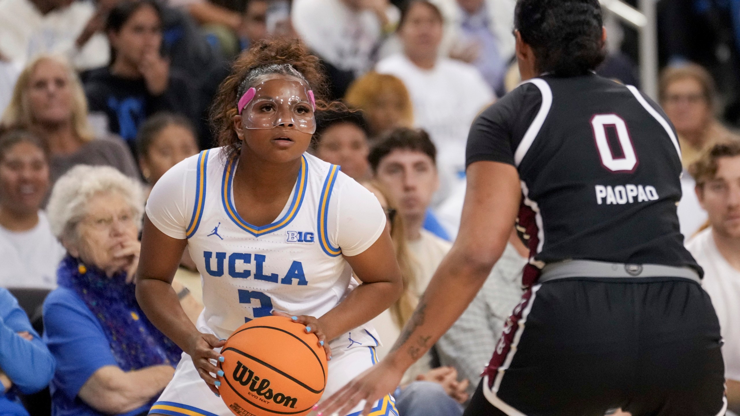 UCLA guard Londynn Jones (3) looks to shoot against South Carolina guard Te-Hina Paopao (0) during the second half of an NCAA college basketball game, Sunday, Nov. 24, 2024, in Los Angeles. (AP Photo/Eric Thayer)