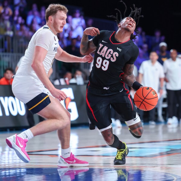 In this handout provided by Bahamas Visual Services, Gonzaga guard Khalif Battle (99) drives against West Virginia guard Tucker DeVries, left, during an NCAA college basketball game at the Battle 4 Atlantis tournament in Paradise Island, Bahamas Wednesday, Nov. 27, 2024. (Tim Aylen/Bahamas Visual Services via AP)