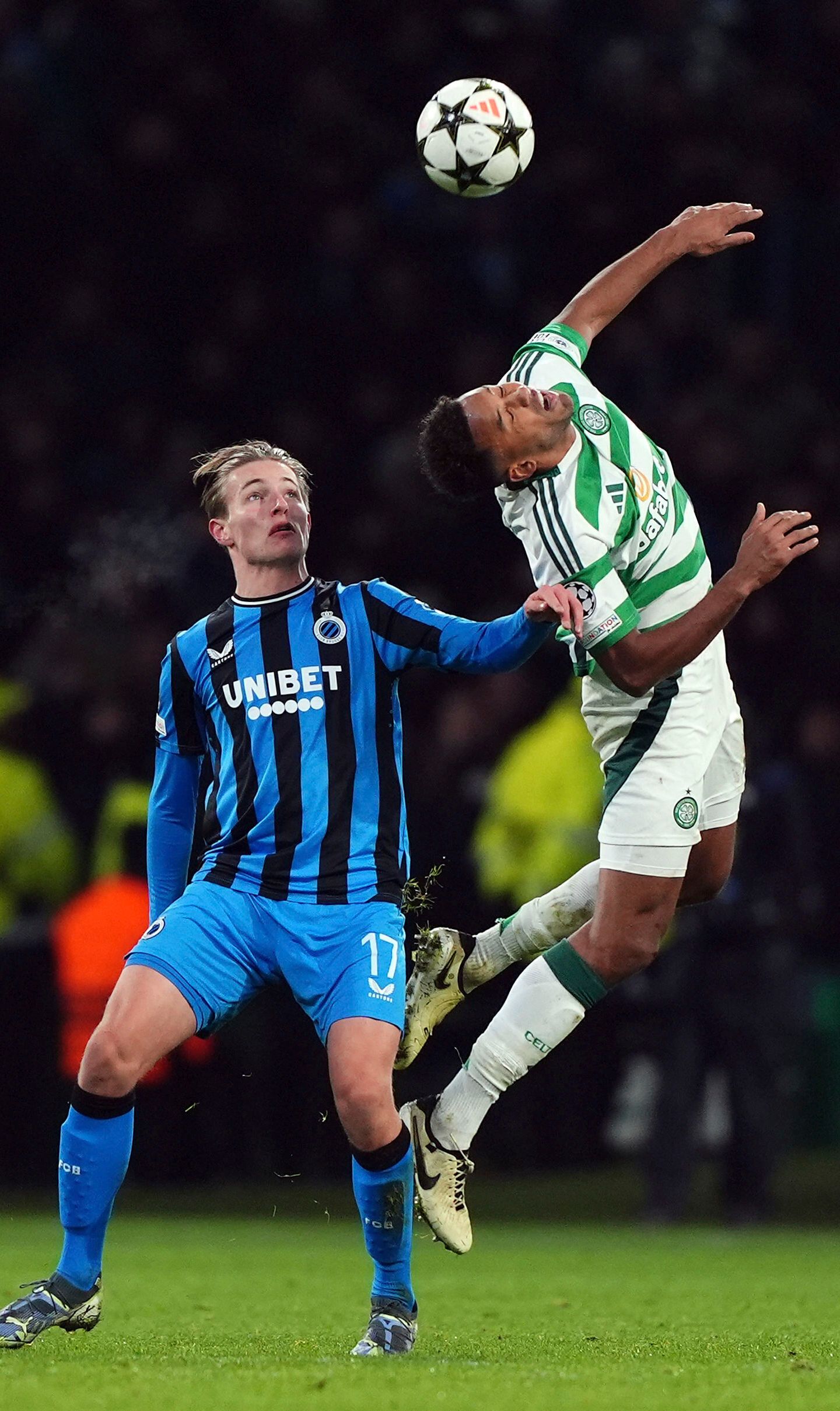 Celtic's Auston Trusty and Club Brugge's Romeo Vermant, left, in action during the UEFA Champions League opening phase soccer stage match at Celtic Park, Glasgow, Scotland, Wednesday Nov. 27, 2024. (Andrew Milligan/PA via AP)