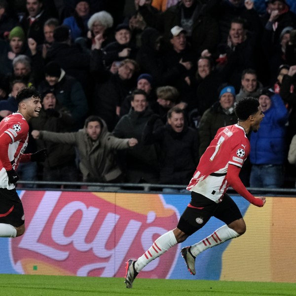 PSV's Malik Tillman, right, celebrates after scoring his sides first goal during the Champions League opening phase soccer match between PSV Eindhoven and Shakhtar Donetsk at the PSV Stadium in Eindhoven, Netherlands, Wednesday, Nov. 27, 2024. (AP Photo/Patrick Post)