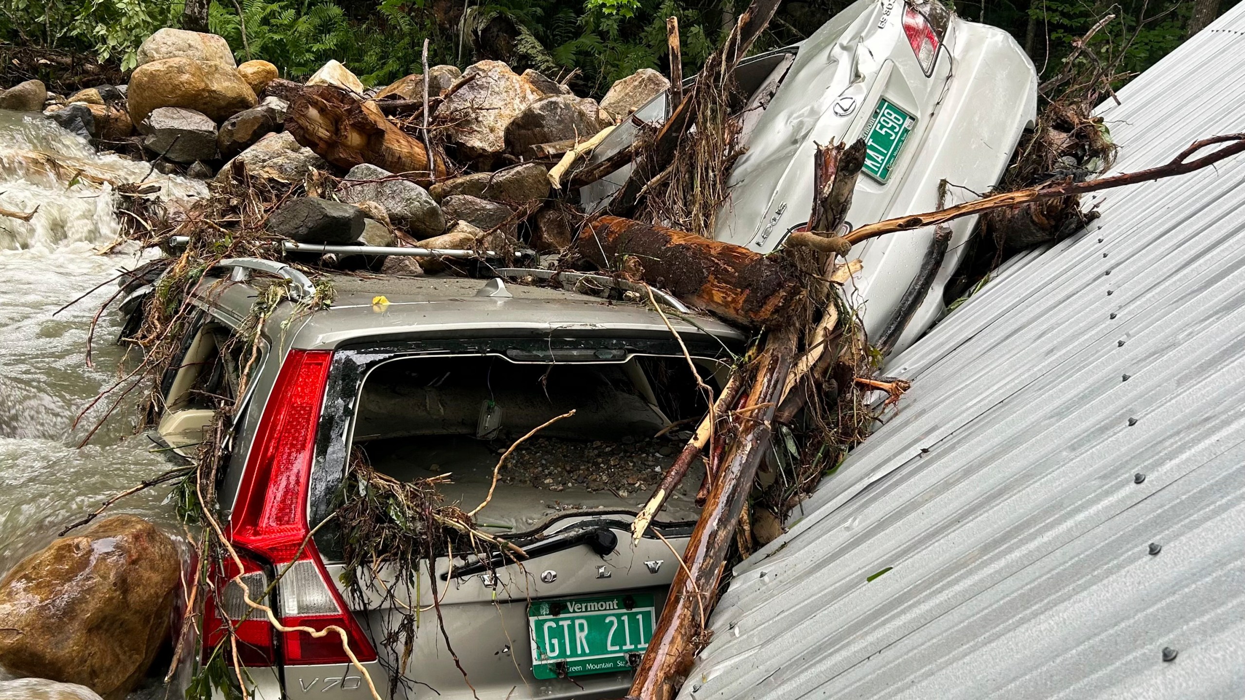 The Mackenzie family's flood-ravaged cars are shown on July 12, 2024, in Peacham, Vt., after severe flooding destroyed their home and vehicles. (Courtesy of Cornelia Hasenfuss via AP)