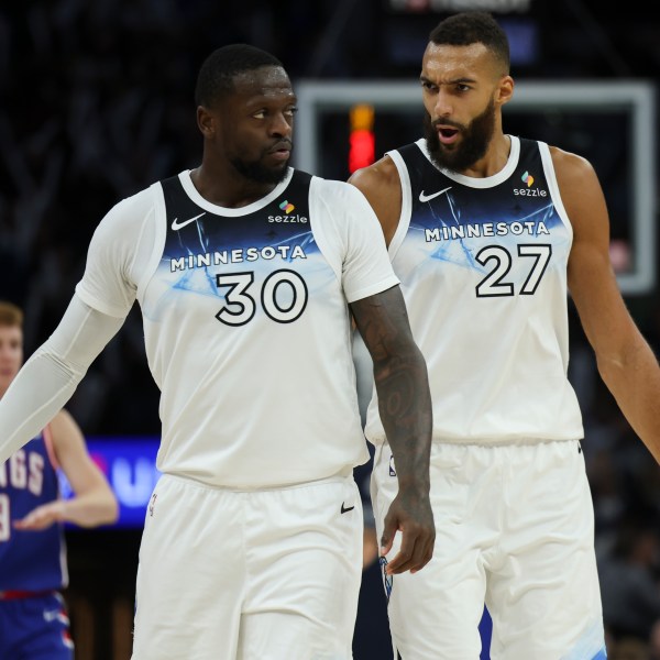 Minnesota Timberwolves forward Julius Randle (30) and center Rudy Gobert (27) react during the second half of an NBA basketball game against the Sacramento Kings, Wednesday, Nov. 27, 2024, in Minneapolis. (AP Photo/Ellen Schmidt)