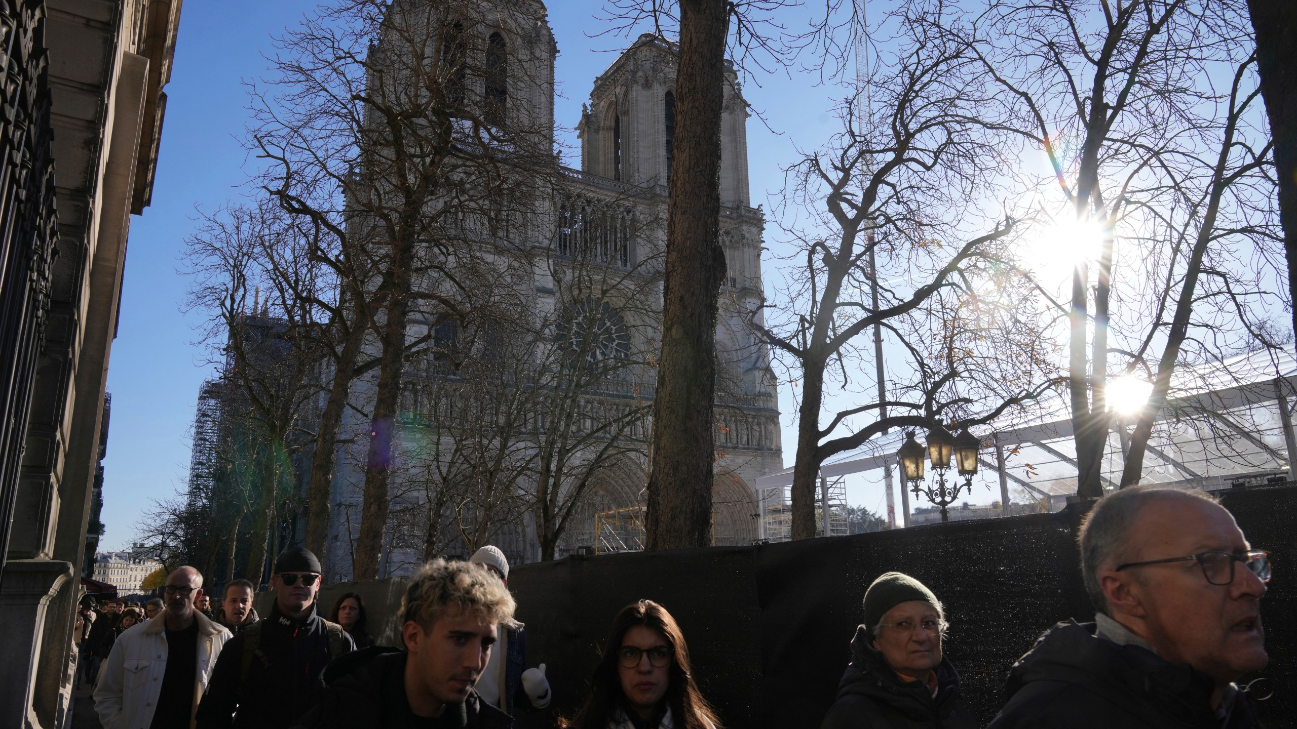 People walk by a security perimeter next to Notre-Dame cathedral, Thursday, Nov. 28, 2024 in Paris. (AP Photo/Michel Euler)