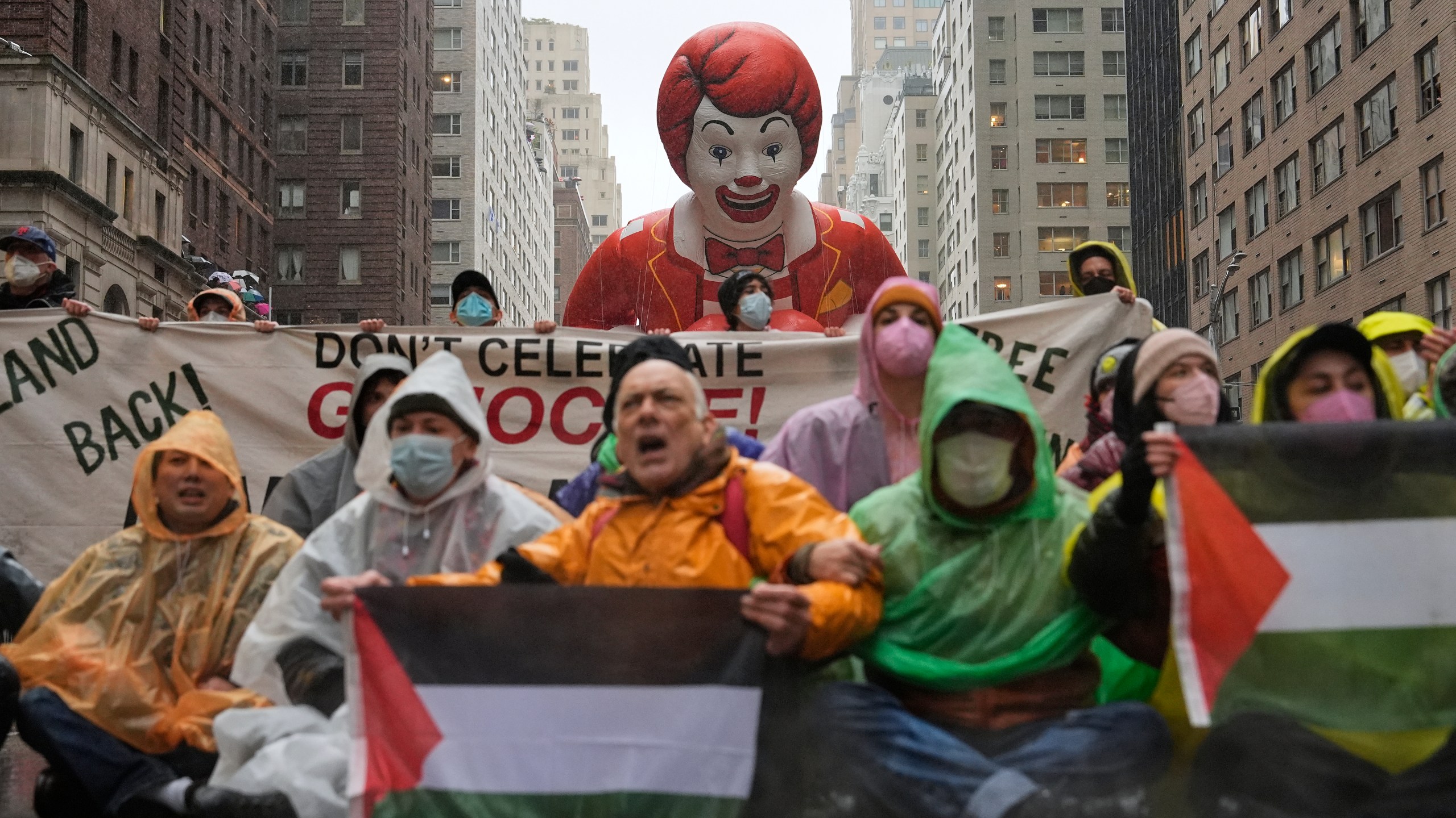 Pro-Palestinian protesters demonstrate on Sixth Avenue during the Macy's Thanksgiving Day Parade, Thursday, Nov. 28, 2024, in New York. (AP Photo/Julia Demaree Nikhinson)