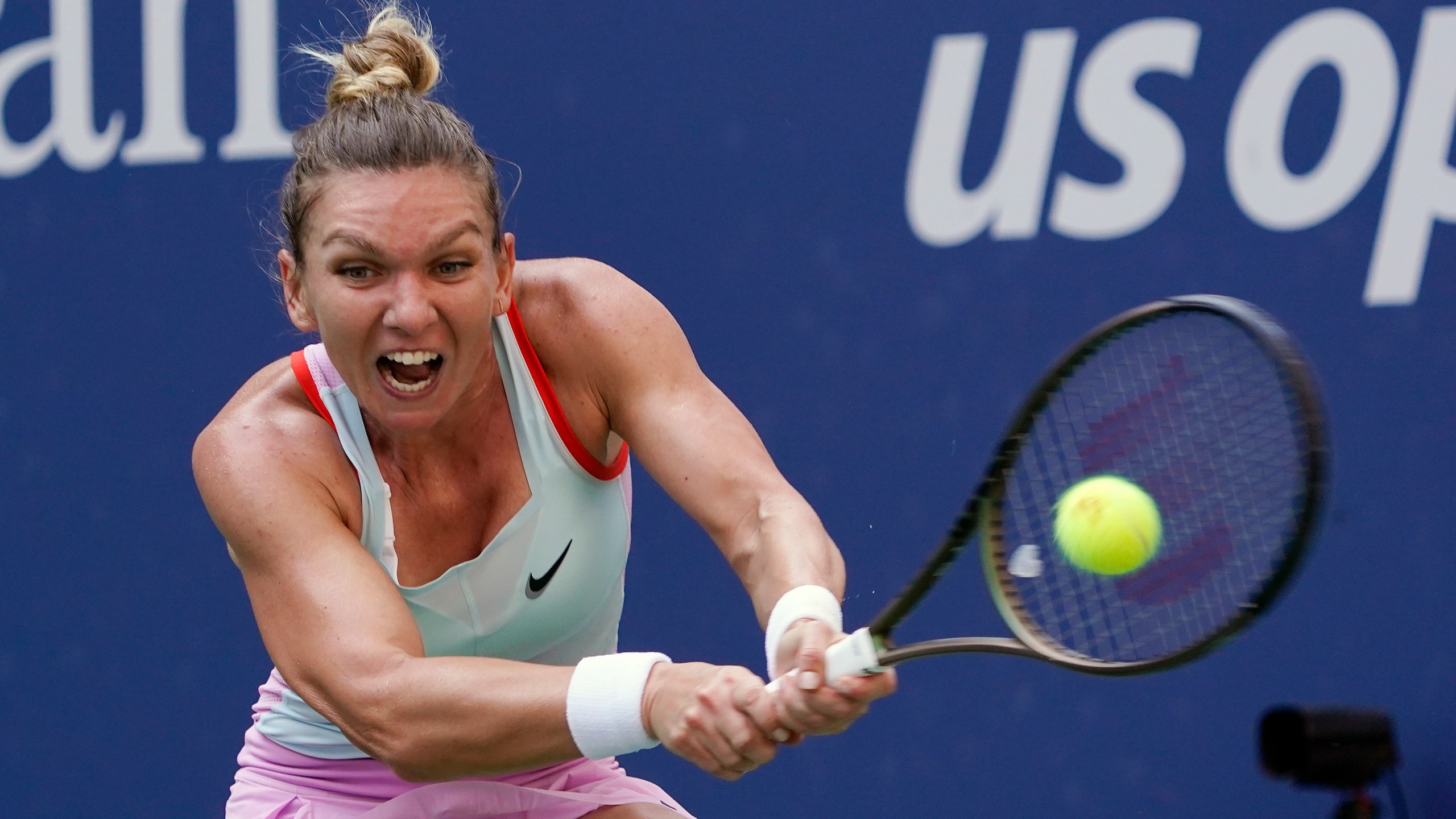 FILE - Simona Halep, of Romania, returns a shot to Daria Snigur, of Ukraine, during the first round of the U.S. Open tennis championships Aug. 29, 2022, in New York. (AP Photo/Seth Wenig, File)