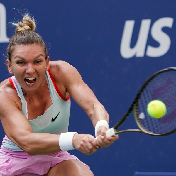 FILE - Simona Halep, of Romania, returns a shot to Daria Snigur, of Ukraine, during the first round of the U.S. Open tennis championships Aug. 29, 2022, in New York. (AP Photo/Seth Wenig, File)