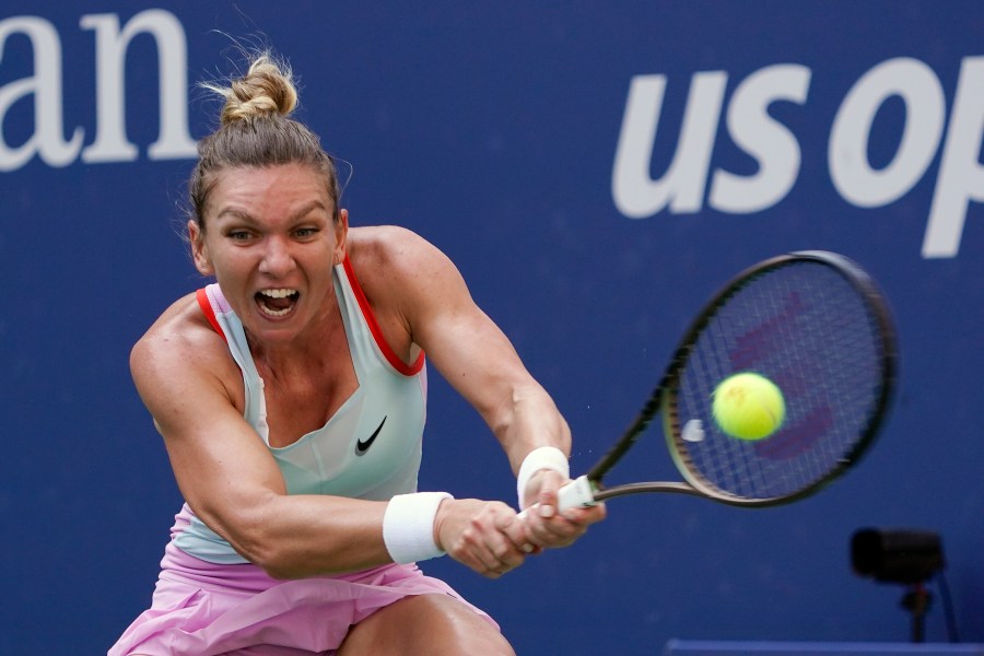 FILE - Simona Halep, of Romania, returns a shot to Daria Snigur, of Ukraine, during the first round of the U.S. Open tennis championships Aug. 29, 2022, in New York. (AP Photo/Seth Wenig, File)