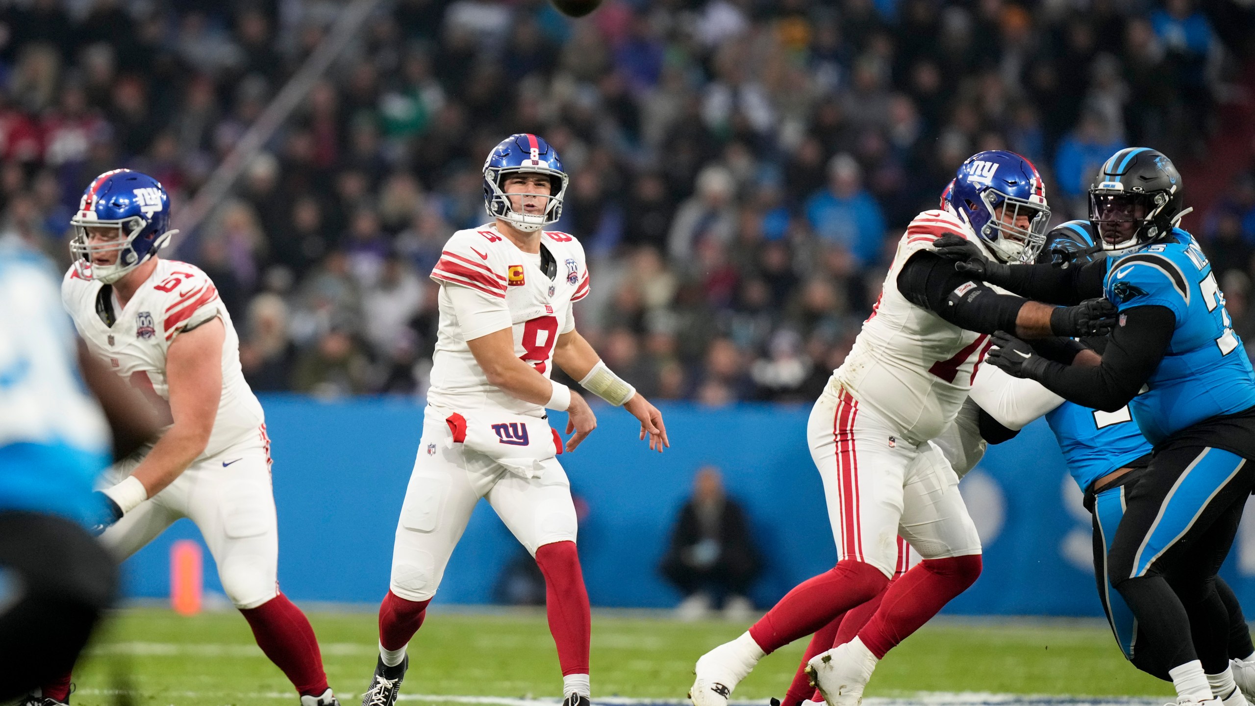 New York Giants quarterback Daniel Jones passes against the Carolina Panthers during the first half of an NFL football game, Sunday, Nov. 10, 2024, in Munich, Germany. (AP Photo/Matthias Schrader)