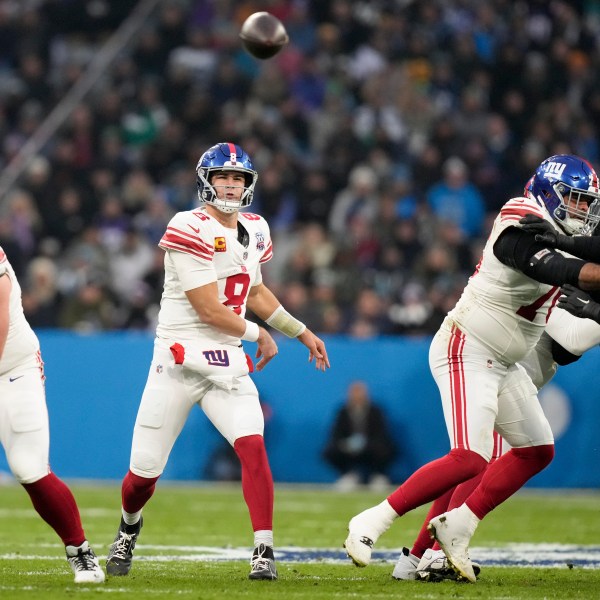 New York Giants quarterback Daniel Jones passes against the Carolina Panthers during the first half of an NFL football game, Sunday, Nov. 10, 2024, in Munich, Germany. (AP Photo/Matthias Schrader)