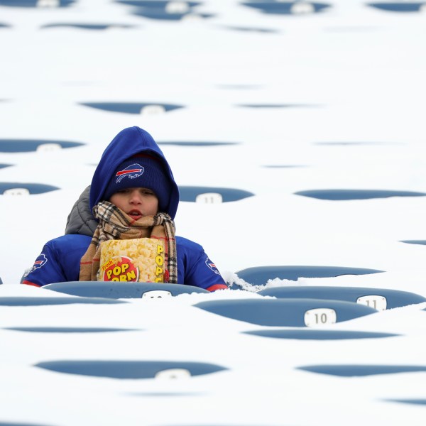 FILE - In this photo from last January, a Buffalo Bills fan sits amongst snow covered seats while waiting for the start an NFL wild-card playoff football game between the Buffalo Bills and the Pittsburgh Steelers, Jan. 15, 2024, in Buffalo, N.Y. (AP Photo/Jeffrey T. Barnes, File)