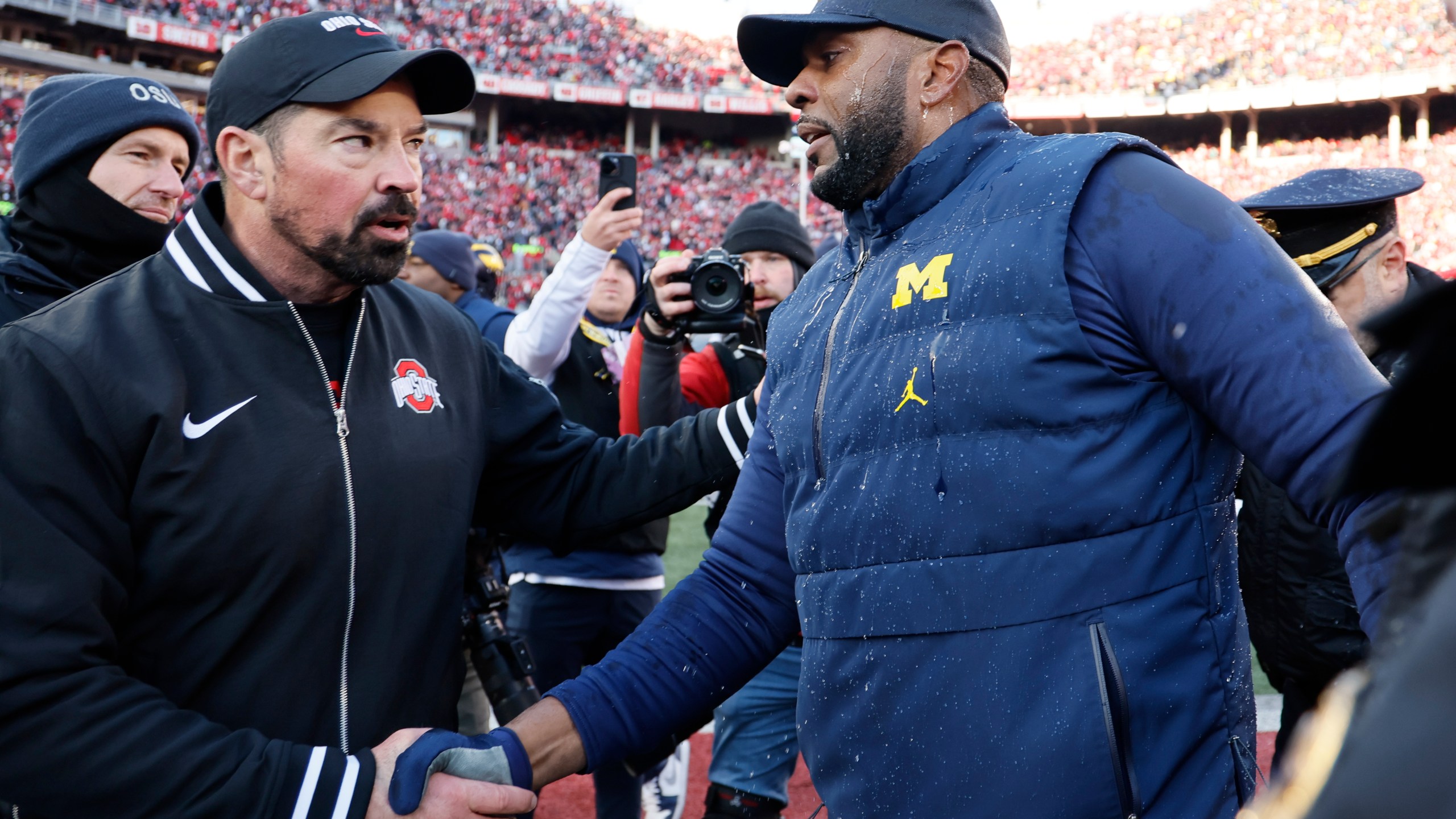 Ohio State head coach Ryan Day, left, and Michigan head coach Sherrone Moore shake hands after an NCAA college football game Saturday, Nov. 30, 2024, in Columbus, Ohio. (AP Photo/Jay LaPrete)