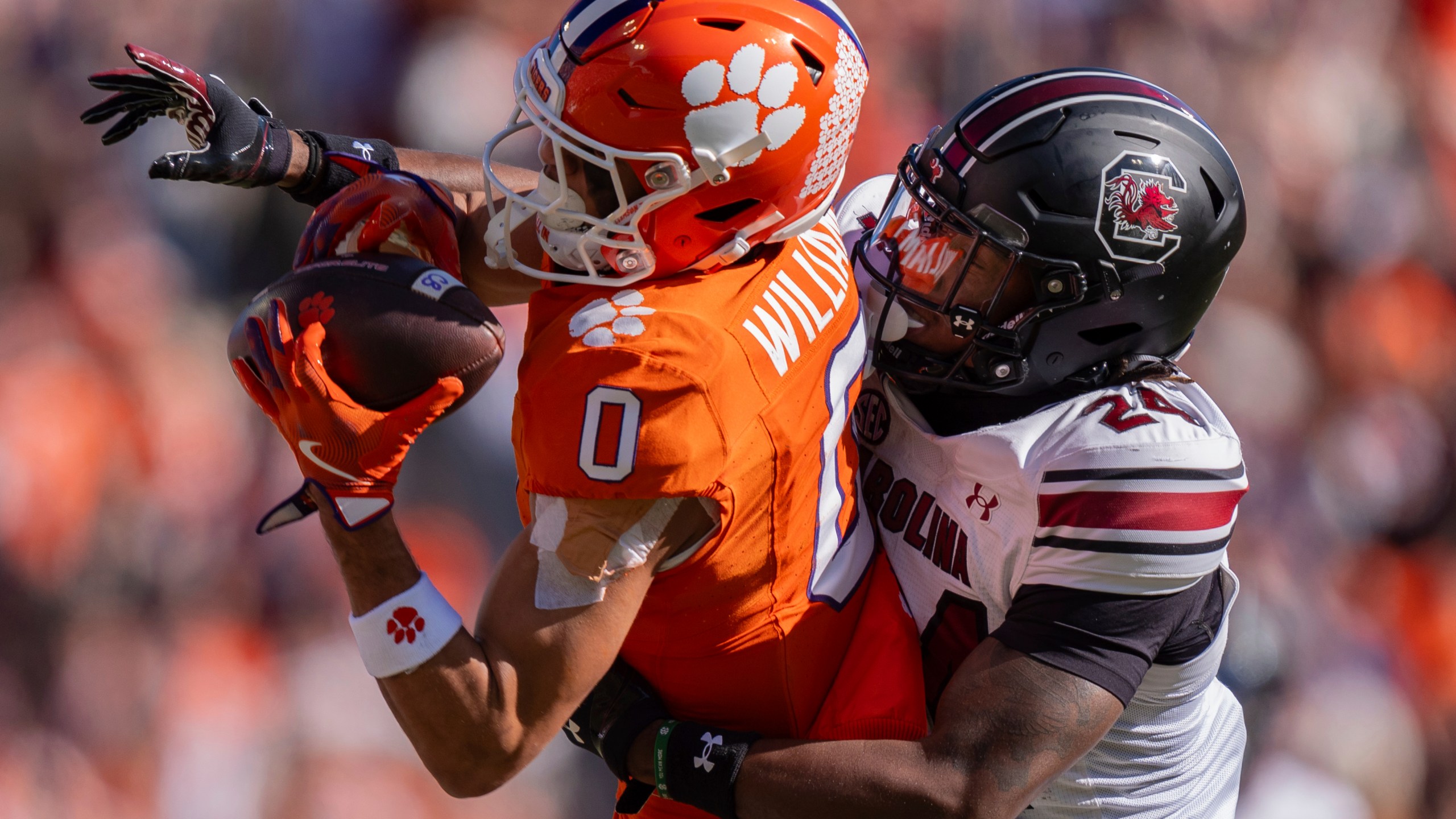 Clemson wide receiver Antonio Williams (0) catches a pass while defended by South Carolina defensive back Jalon Kilgore (24) in the first half of an NCAA college football game Saturday, Nov. 30, 2024, in Clemson, S.C. (AP Photo/Jacob Kupferman)