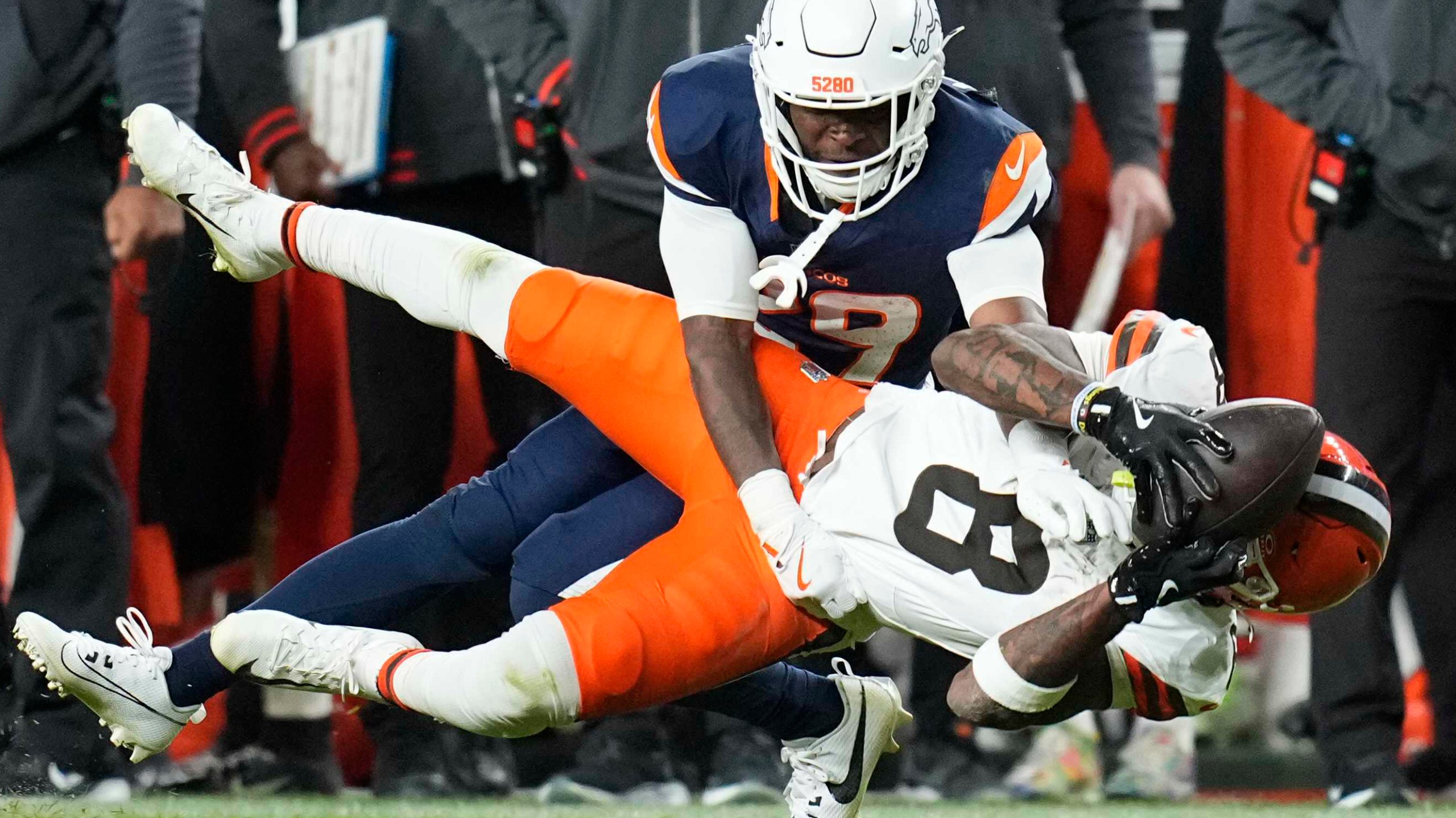 Cleveland Browns wide receiver Elijah Moore (8) is defended by Denver Broncos cornerback Ja'Quan McMillian (29) during the second half of an NFL football game, Monday, Dec. 2, 2024, in Denver. (AP Photo/Jack Dempsey)