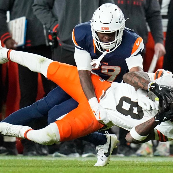 Cleveland Browns wide receiver Elijah Moore (8) is defended by Denver Broncos cornerback Ja'Quan McMillian (29) during the second half of an NFL football game, Monday, Dec. 2, 2024, in Denver. (AP Photo/Jack Dempsey)