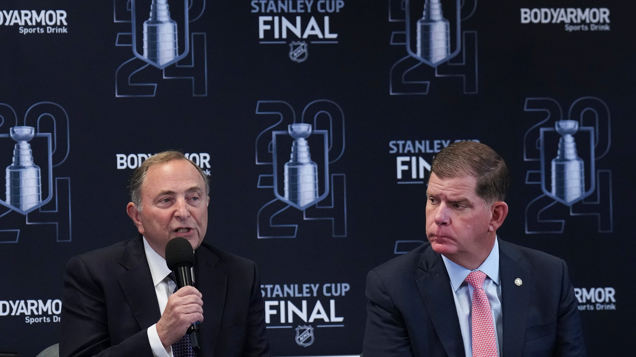 FILE - Gary Bettman, left, commissioner of the NHL, and Marty Walsh, right, executive director of the NHLPA, speak to the media ahead of Game 1 of the NHL hockey Stanley Cup Finals between the Florida Panthers and the Edmonton Oilers in Sunrise, Fla., June 8, 2024. (Nathan Denette/The Canadian Press via AP, file)