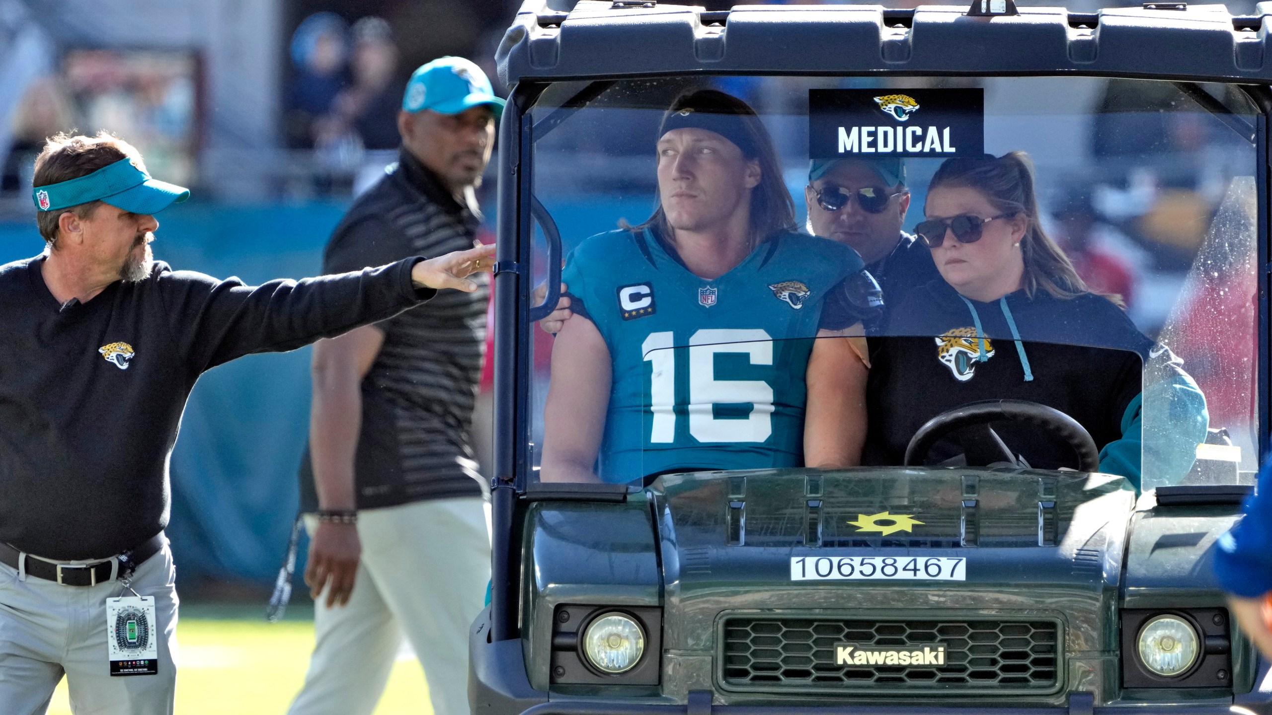 Jacksonville Jaguars quarterback Trevor Lawrence (16) leaves the field on a cart after getting injured on a late hit by Houston Texans linebacker Azeez Al-Shaair during the first half of an NFL football game Sunday, Dec. 1, 2024, in Jacksonville, Fla. (AP Photo/John Raoux)