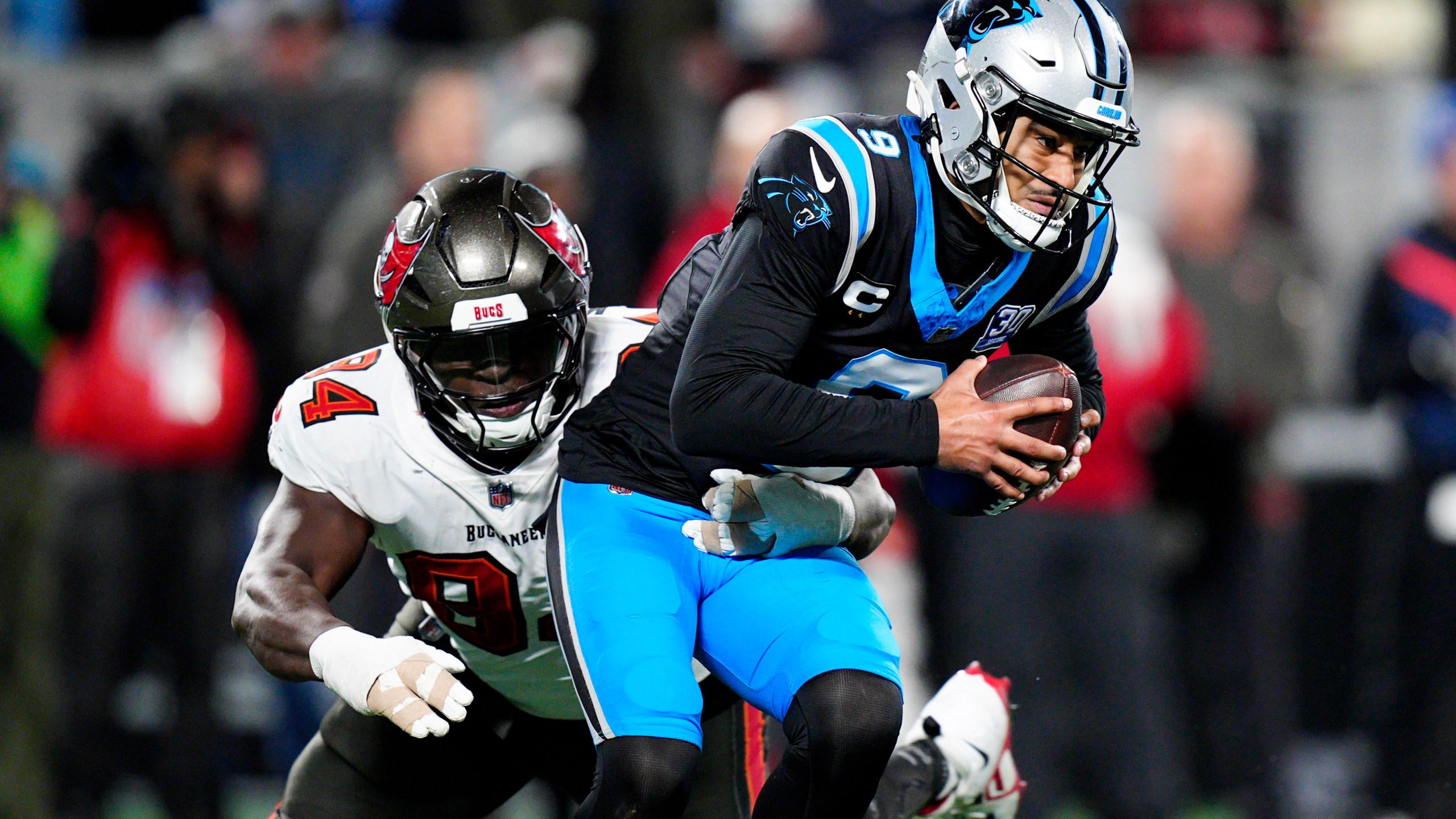 Carolina Panthers quarterback Bryce Young is sacked by Tampa Bay Buccaneers defensive tackle Calijah Kancey during the second half of an NFL football game, Sunday, Dec. 1, 2024, in Charlotte, N.C. (AP Photo/Jacob Kupferman)