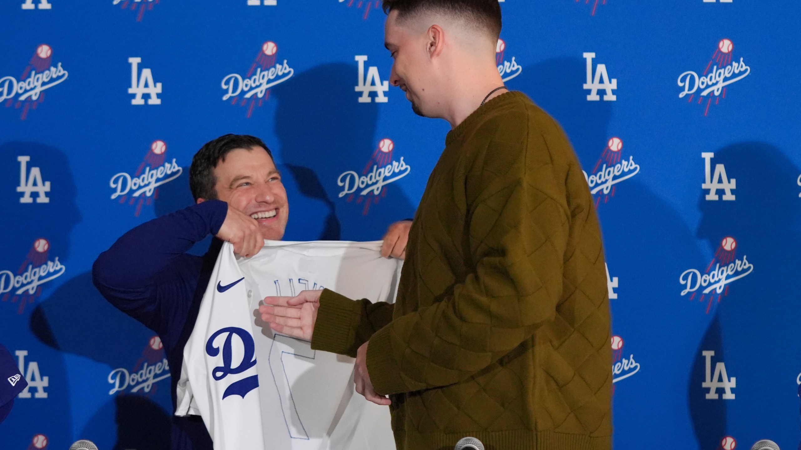 Los Angeles Dodgers pitcher Blake Snell, right, is presented with a jersey by president of baseball operations Andrew Friedman during a news conference Tuesday, Dec. 3, 2024, in Los Angeles. (AP Photo/Jae C. Hong)