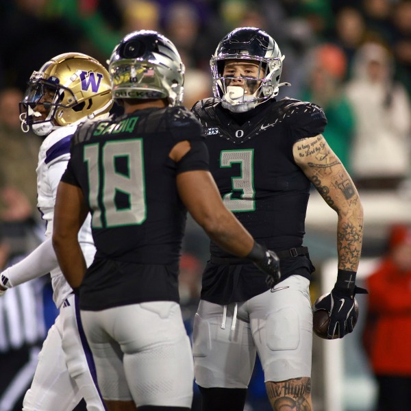 Oregon tight end Kenyon Sadiq (18) congratulates tight end Terrance Ferguson (3) on a first down during an NCAA college football game against Washington, Saturday, Nov. 30, 2024, in Eugene, Ore. (AP Photo/Lydia Ely)