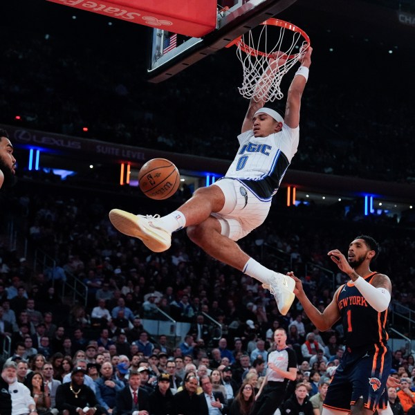 Orlando Magic guard Anthony Black (0) dunks during the first half of an NBA Cup basketball game against the New York Knicks, Tuesday, Dec. 3, 2024, in New York, N.Y. (AP Photo/Julia Demaree Nikhinson)