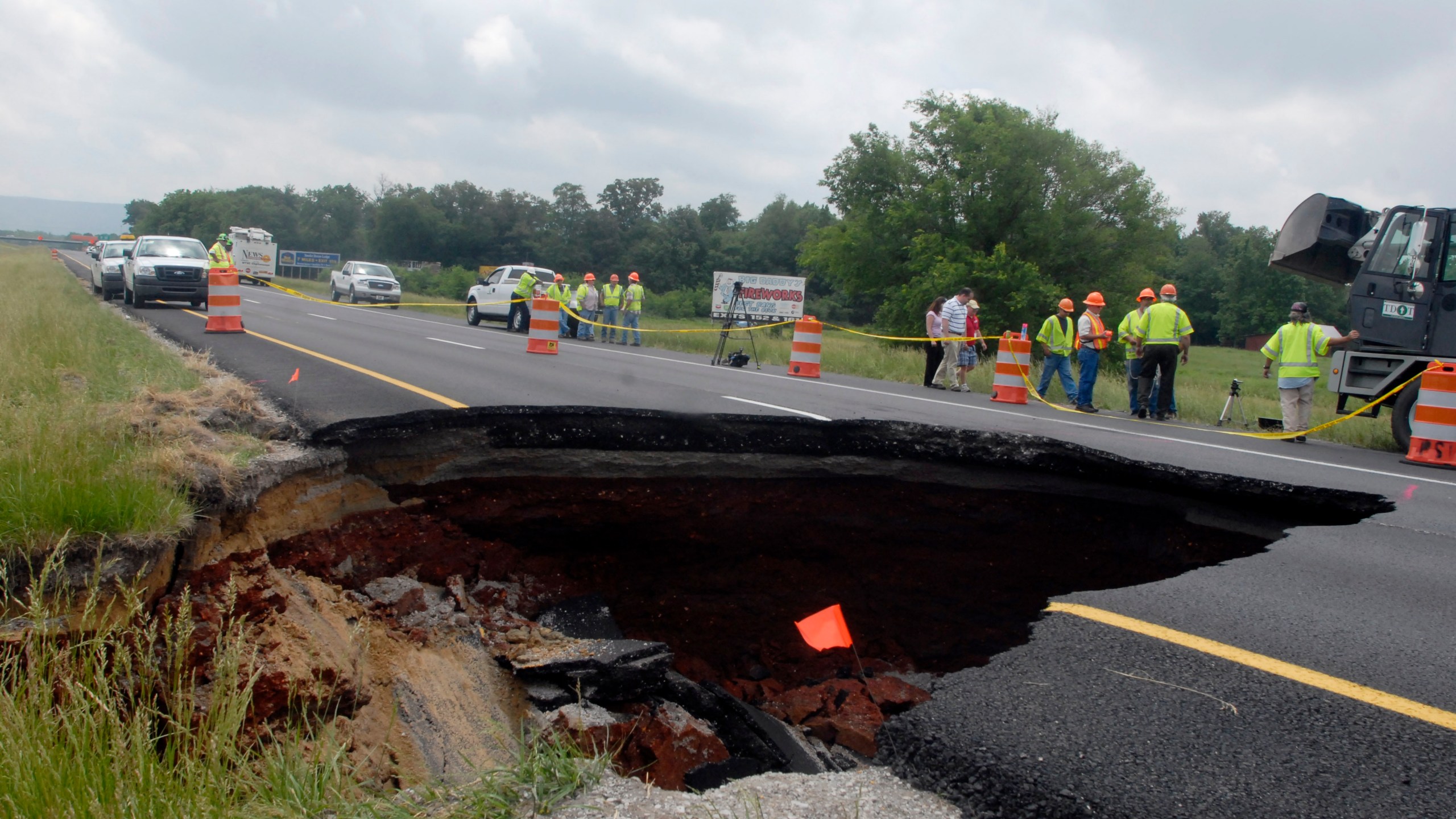 FILE - TDOT workers assess damage done by a sinkhole on eastbound Interstate 24 near Grundy County Tuesday May 18, 2010 near Chattanooga, Tenn. (Danielle Moore/Chattanooga Times Free Press via AP, File)