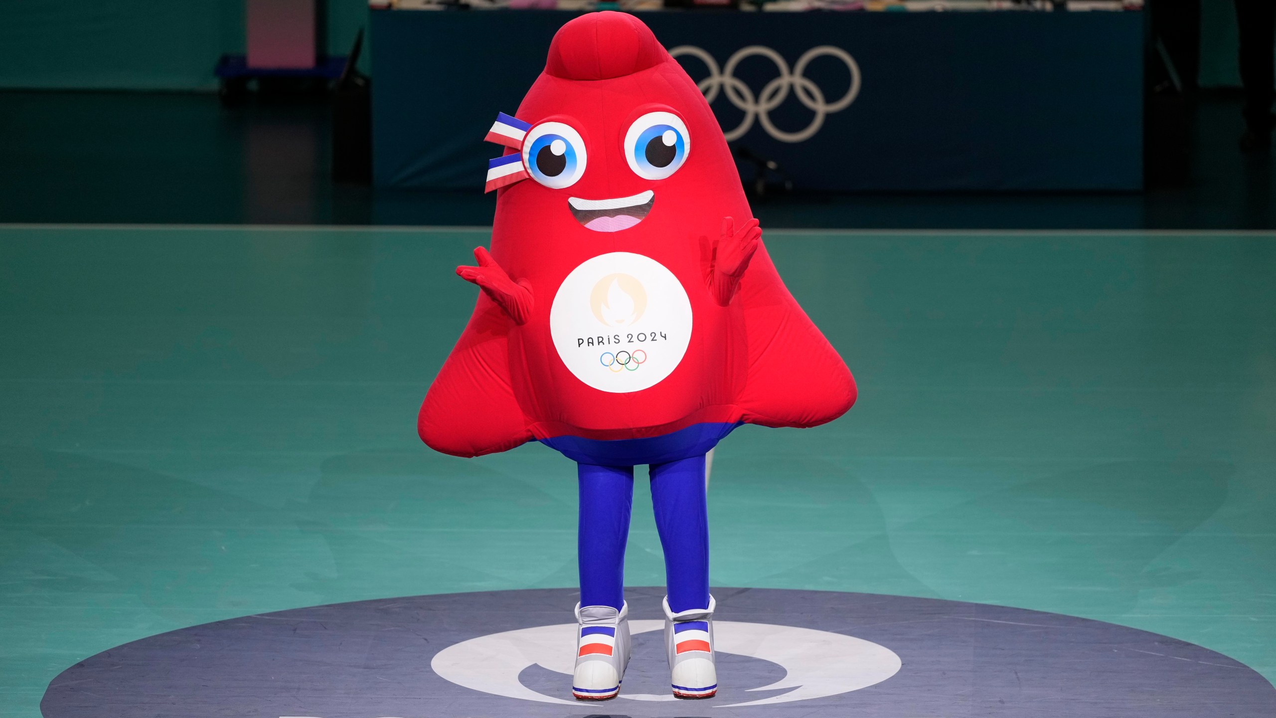 FILE - Phryge, the Olympics 2024 mascot dances at the South Paris Arena, during the men's handball match between Denmark and Egypt at the 2024 Summer Olympics, Monday, July 29, 2024, in Paris, France. (AP Photo/Brian Inganga, File)