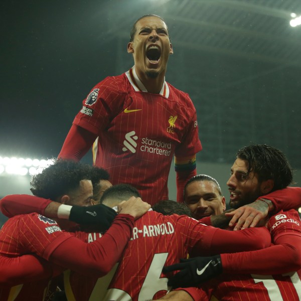 Liverpool's Mohamed Salah celebrates with teammates after scoring his side's third goal during the English Premier League soccer match between Newcastle and Liverpool, at St. James Park in Newcastle, England, Wednesday, Dec 4, 2024. (AP Photo/Ian Hodgson)