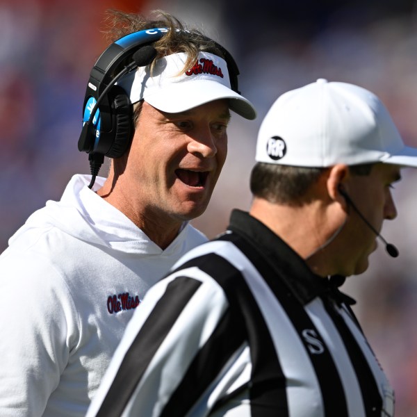 Mississippi head coach Lane Kiffin, left, questions an official on the sideline during the first half of an NCAA college football game against Florida, Saturday, Nov. 23, 2024, in Gainesville, Fla. (AP Photo/Phelan M. Ebenhack)