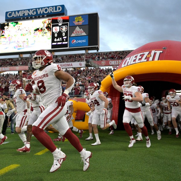 FILE - Oklahoma players run onto the field before the Cheez-It Bowl NCAA college football game against Florida State, Thursday, Dec. 29, 2022, in Orlando, Fla. (AP Photo/Phelan M. Ebenhack, File)