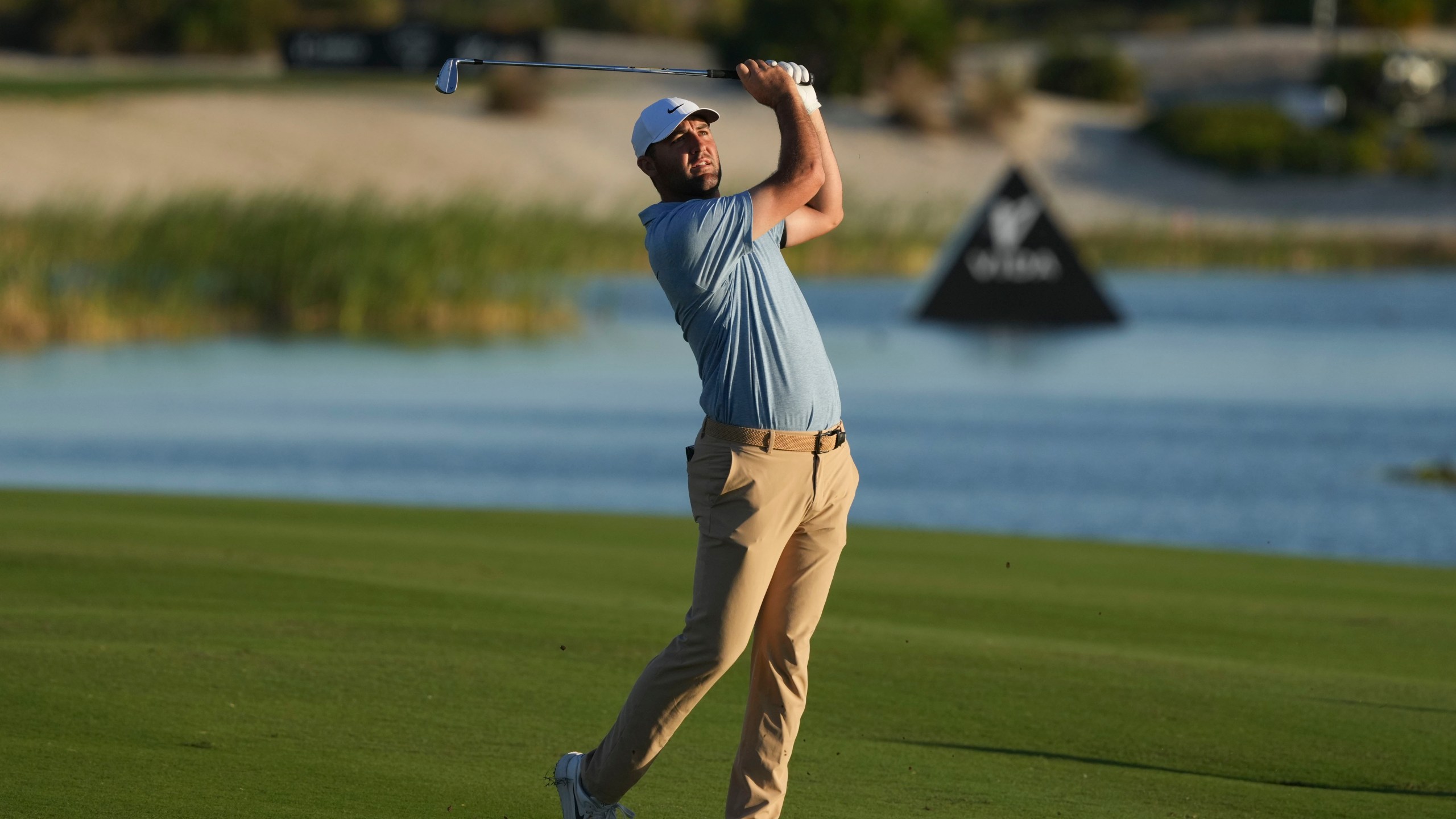 Scottie Scheffler, of the United States, watches his shot from the 18th fairway during the final round of the Hero World Challenge PGA Tour at the Albany Golf Club in New Providence, Bahamas, Sunday, Dec. 8, 2024. (AP Photo/Fernando Llano)