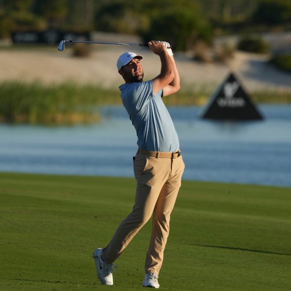 Scottie Scheffler, of the United States, watches his shot from the 18th fairway during the final round of the Hero World Challenge PGA Tour at the Albany Golf Club in New Providence, Bahamas, Sunday, Dec. 8, 2024. (AP Photo/Fernando Llano)