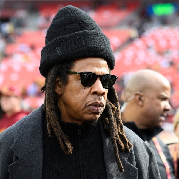 FILE - Musician Jay-Z stands on the field before an NFL football game between the Washington Commanders and Dallas Cowboys, on Nov. 24, 2024, in Landover, Md. (AP Photo/Nick Wass, File)