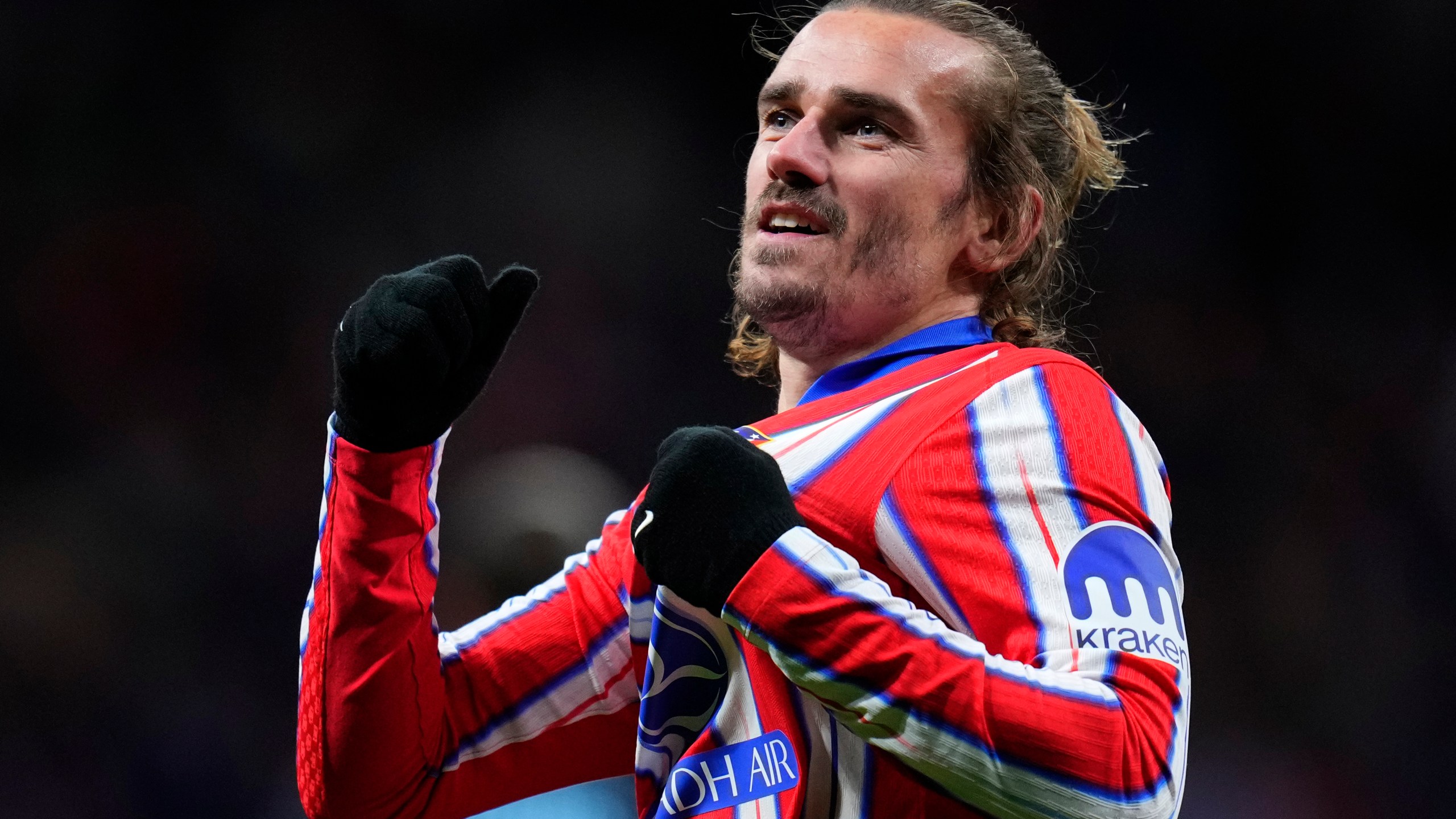 Atletico Madrid's Antoine Griezmann celebrates after scoring his side's third goal during the Champions League opening phase soccer match between Atletico Madrid and Slovan Bratislava at Riyadh Air Metropolitano stadium in Madrid, Spain, Wednesday, Dec. 11, 2024. (AP Photo/Manu Fernandez)