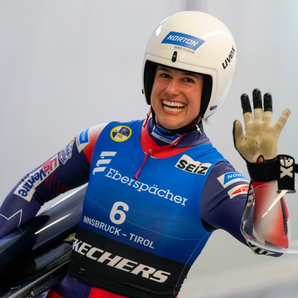 Emily Sweeney of the United States waves after the women's sprint race at the Luge World Cup in Igls near Innsbruck, Austria, Saturday, Dec. 7, 2024. (AP Photo/Matthias Schrader)