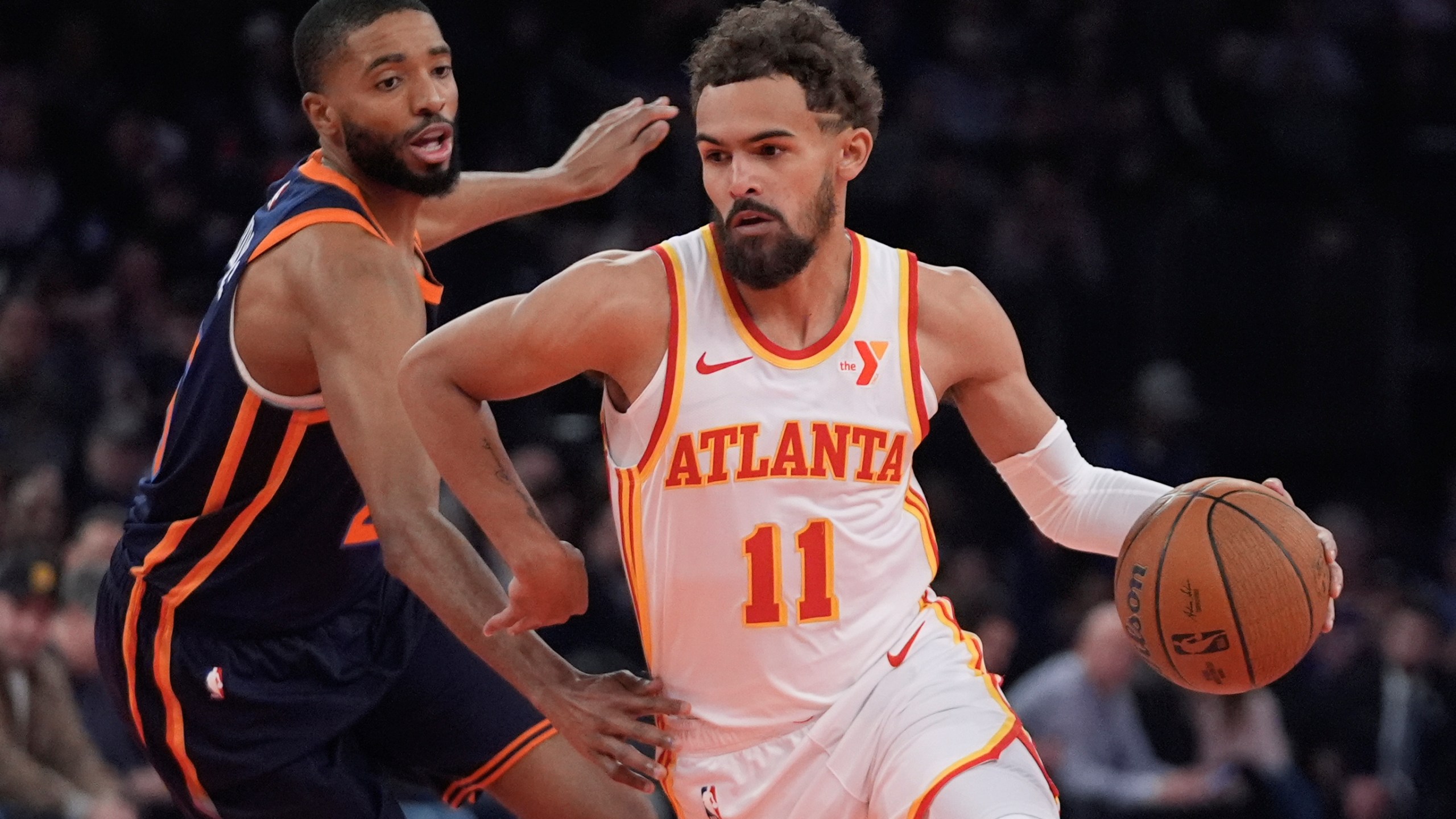 Atlanta Hawks' Trae Young (11) drives past New York Knicks' Mikal Bridges during the first half of an Emirates NBA Cup basketball game Wednesday, Dec. 11, 2024, in New York. (AP Photo/Frank Franklin II)