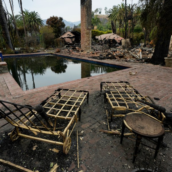 Burned outdoor furniture is left behind on a property after the Franklin Fire swept through, Wednesday, Dec. 11, 2024, in Malibu, Calif. (AP Photo/Damian Dovarganes)