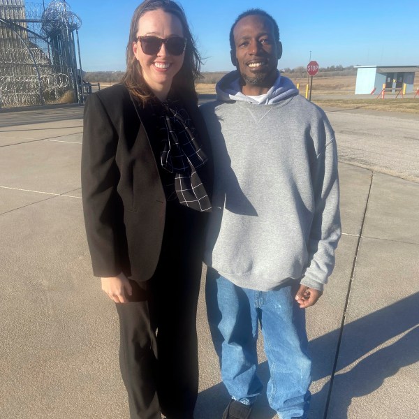 In this photo provided by Bob Hoffman, Dominique Moore, 40, poses with one of his attorneys, Courtney Stout, after he was released from prison when a judge overturned his conviction in a double homicide case, Wednesday, Dec. 11, 2024, in El Dorado, Kan. (Bob Hoffman via AP)