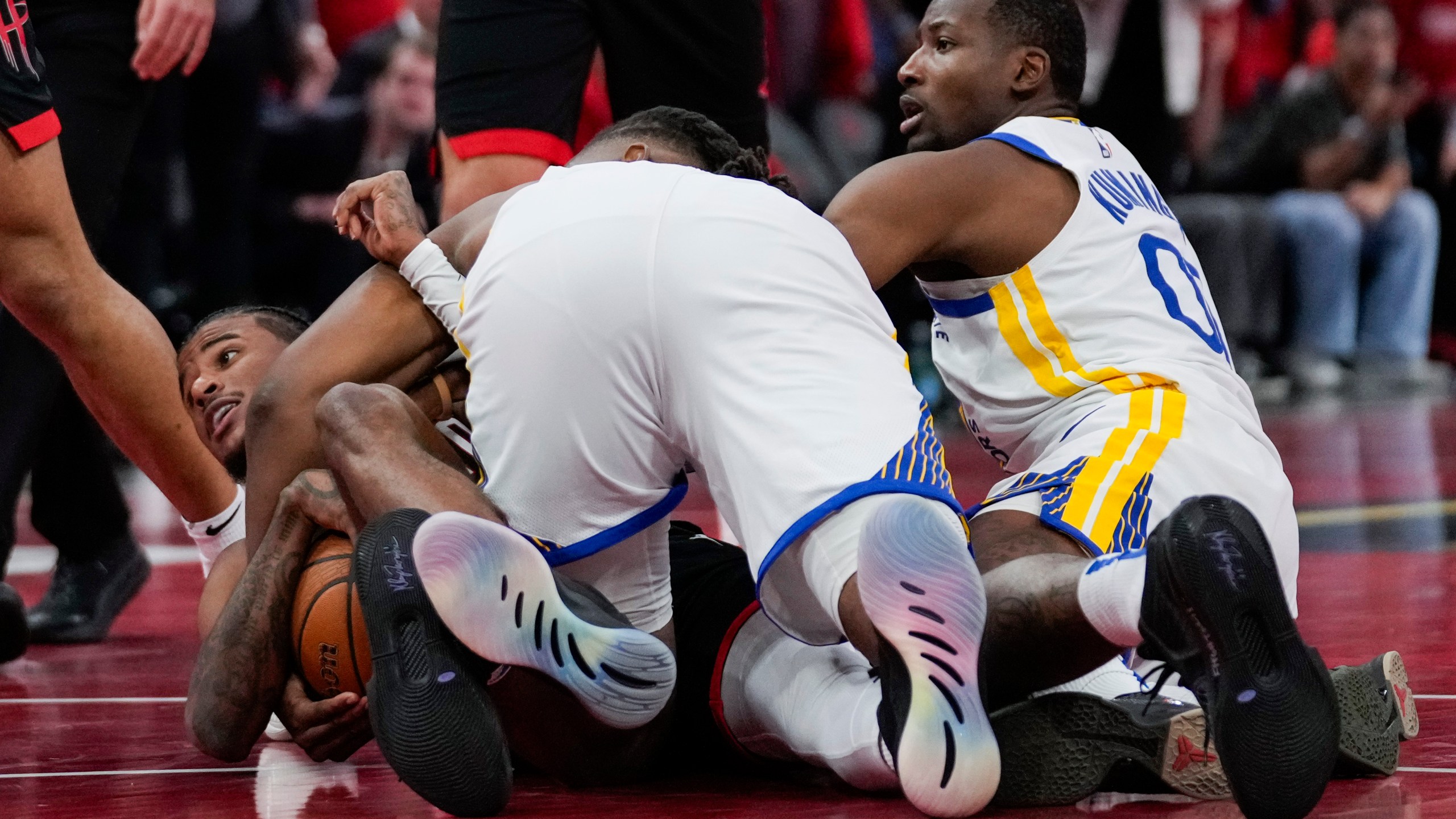 Golden State Warriors forward Jonathan Kuminga (00) fouls Houston Rockets guard Jalen Green, left, during the second half of an Emirates NBA cup tournament quarterfinal basketball game in Houston, Wednesday, Dec. 11, 2024. (AP Photo/Ashley Landis)