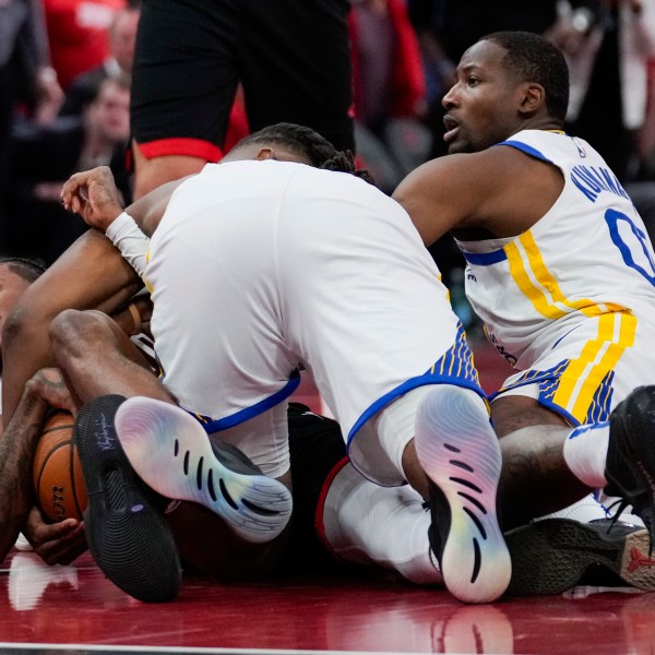 Golden State Warriors forward Jonathan Kuminga (00) fouls Houston Rockets guard Jalen Green, left, during the second half of an Emirates NBA cup tournament quarterfinal basketball game in Houston, Wednesday, Dec. 11, 2024. (AP Photo/Ashley Landis)