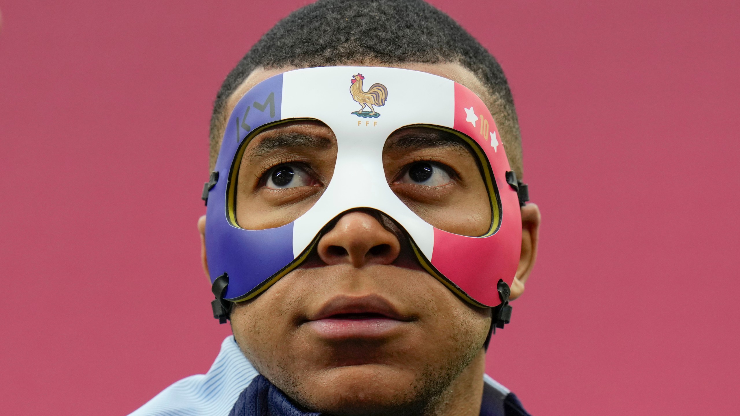 FILE - France's Kylian Mbappe looks up as he wears a face mask during a team training session in Leipzig, Germany, Thursday, June 20, 2024. (AP Photo/Hassan Ammar, file)