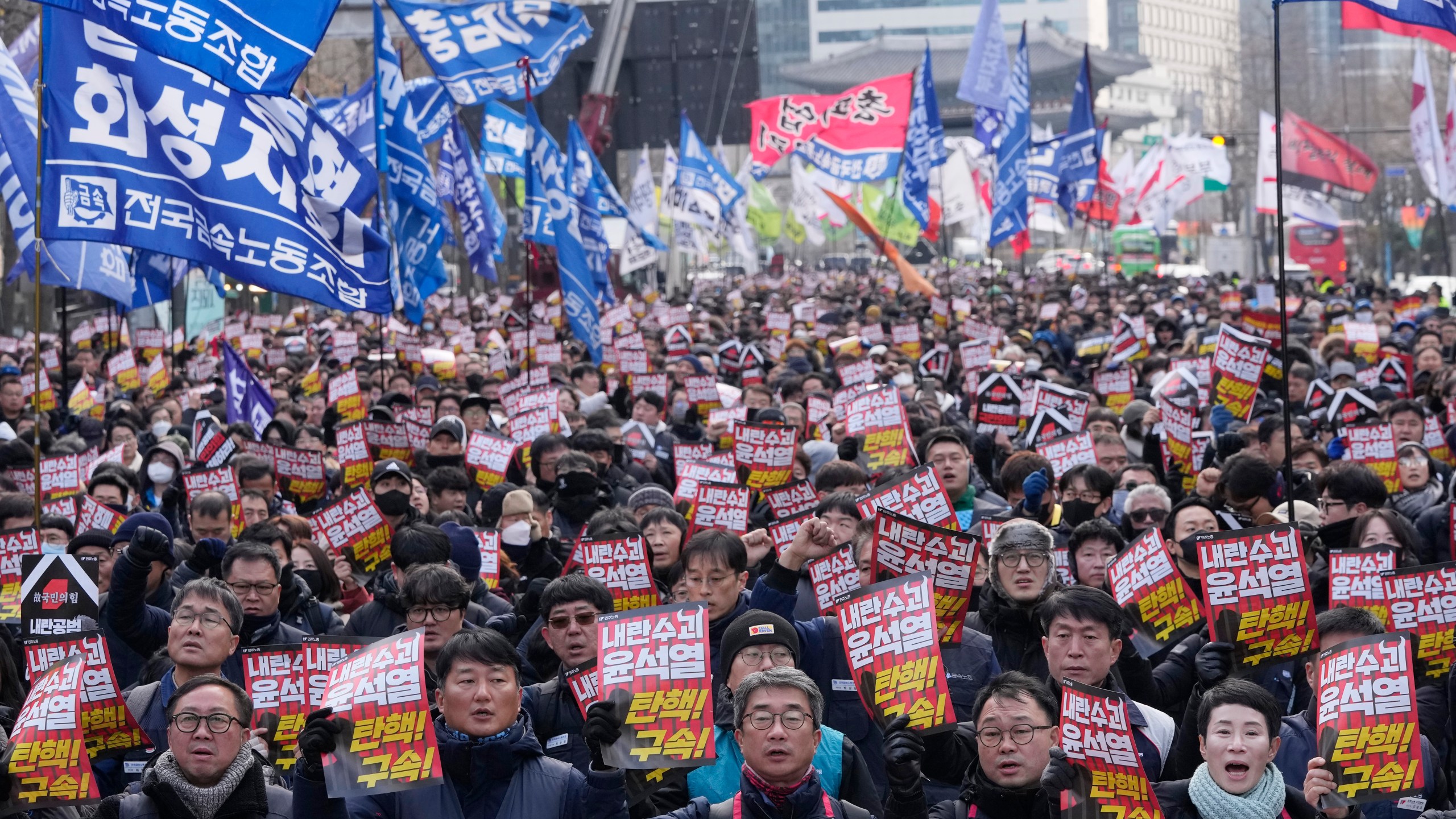 Protesters stage a rally demanding South Korean President Yoon Suk Yeol's impeachment in Seoul, South Korea, Thursday, Dec. 12, 2024. The signs read "Arrest the rebellion leader Yoon Suk Yeol." (AP Photo/Ahn Young-joon)