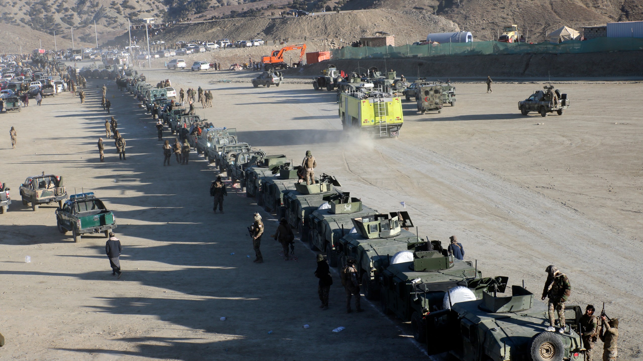 Taliban fighters stand guard during the funeral prayers of Khalil Haqqani, the minister for refugees and repatriation, during his funeral procession in eastern Paktia province, Afghanistan, Thursday, Dec. 12, 2024. (AP Photo/Saifullah Zahir)