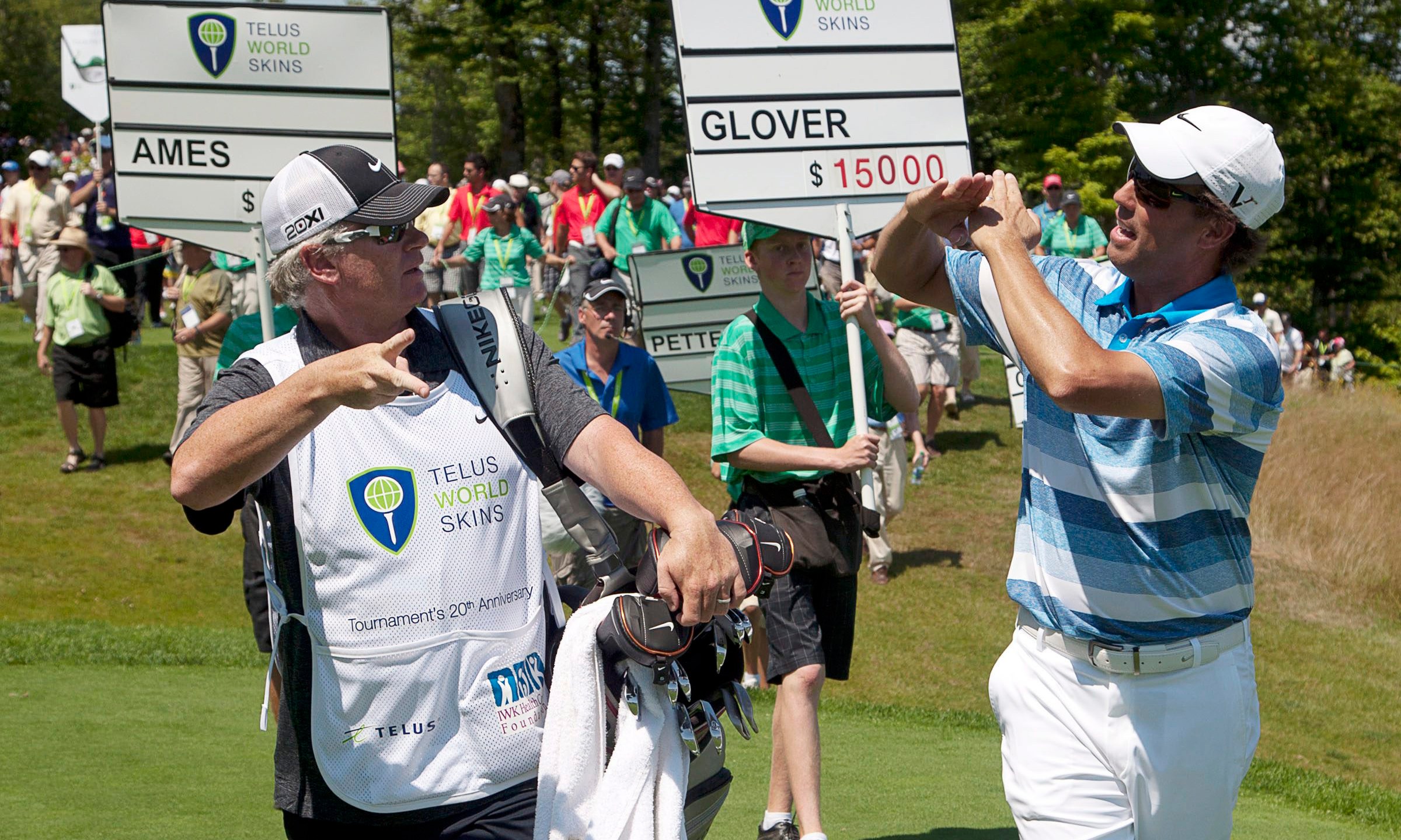 FILE - Canada's Steve Ames, right, and his caddie, Adrian Watey, chat during the Telus World Skins game at Glen Arbour golf course in Halifax, Nova Scotia, on Tuesday, July 31, 2012. (Andrew Vaughan/The Canadian Press via AP, File)