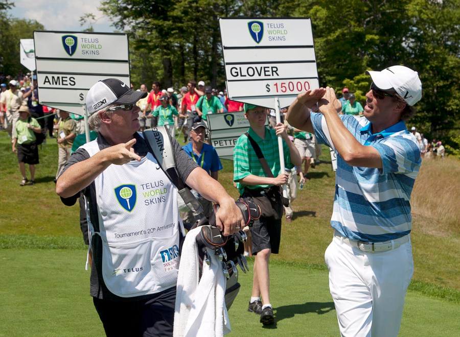 FILE - Canada's Steve Ames, right, and his caddie, Adrian Watey, chat during the Telus World Skins game at Glen Arbour golf course in Halifax, Nova Scotia, on Tuesday, July 31, 2012. (Andrew Vaughan/The Canadian Press via AP, File)