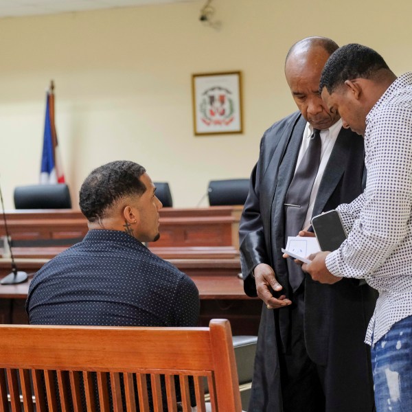 Tampa Bay Rays shortstop Wander Franco, left, attends his trial on charges of sexually abusing a minor, sexual and commercial exploitation against a minor and human trafficking, accompanied by his lawyer Teodosio Jaquez, center, in Puerto Plata, Dominican Republic, Thursday, Dec. 12, 2024. (AP Photo/Ricardo Hernandez)