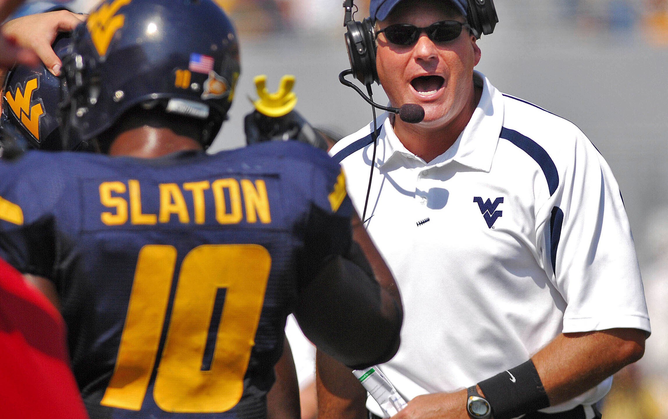 FILE - West Virginia coach Rich Rodriguez yells onto the field during the second half of a college football game against East Carolina in this Sept. 22, 2007 file photo, in Morgantown, W.Va. (AP Photo/Jeff Gentner, File)