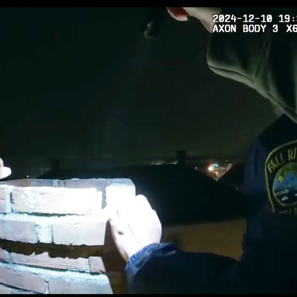 This image provided by City of Fall River Police Department shows police encounter of a man attempting to evade arrest by hiding inside a chimney on Tuesday, Dec. 10, 2024 in Fall River, Mass. (City of Fall River Police Department via AP)